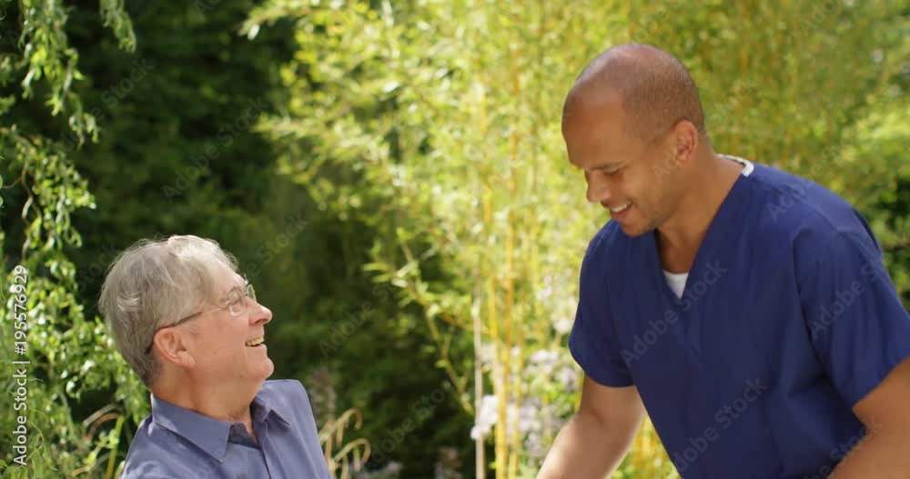 4K Cheerful senior man relaxing in the garden & chatting to home care assistant. 4K Cheerful senior man relaxing in the garden & chatting to home care assistant.