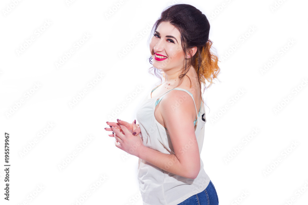 Studio portrait of a beautiful young woman with black hair gathered in a tail. A girl in a T-shirt and jeans poses against a white background. He looks at the camera. Isolate Studio portrait of a beautiful young woman with black hair gathered in a tail. A girl in a T-shirt and jeans poses against a white background. He looks at the camera. Isolate