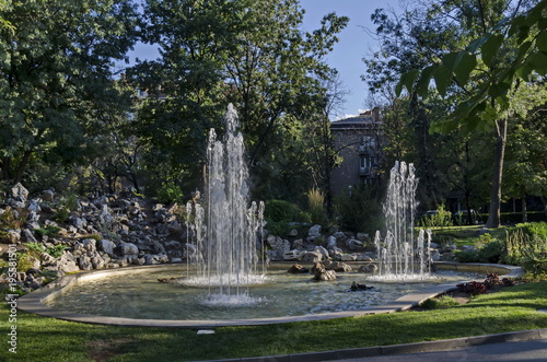 Group from small water fountains flowing in front beauty rockery, Sofia, Bulgaria 