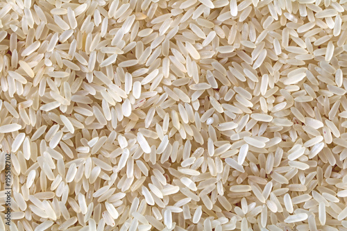  Rice texture. White long rice background, uncooked raw cereals, macro closeup. photo