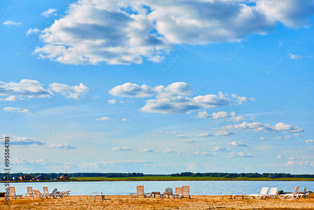 Sun loungers on the deserted river beach. Place of rest in Russia