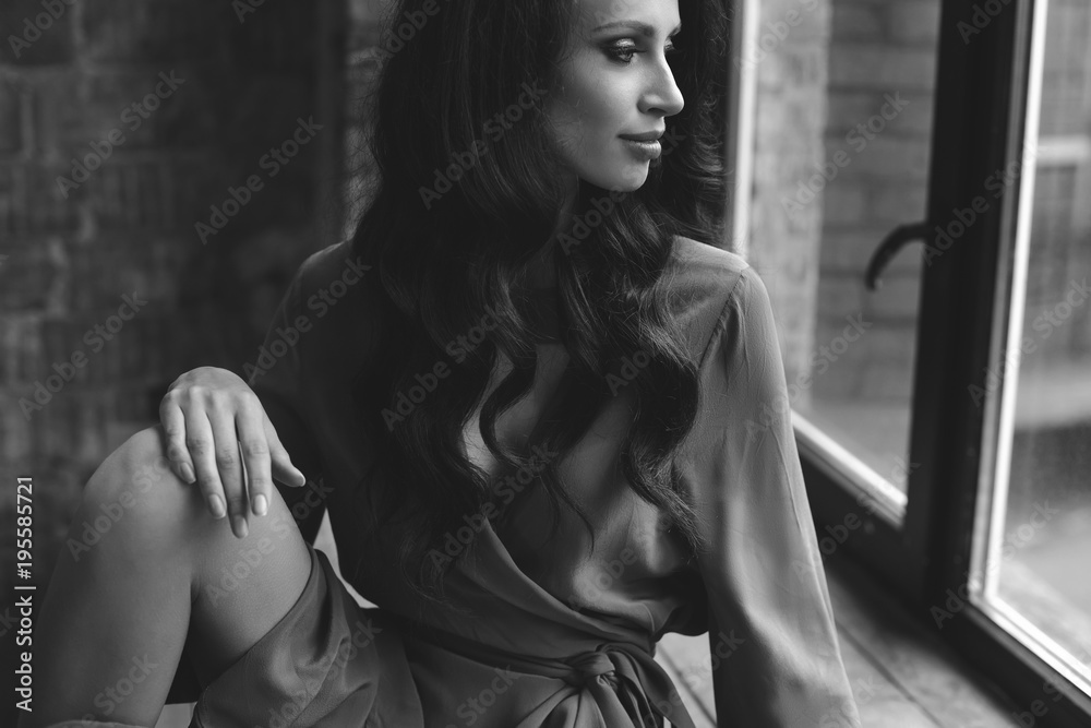young beautiful girl is sitting by the window. young beautiful girl is sitting by the window.