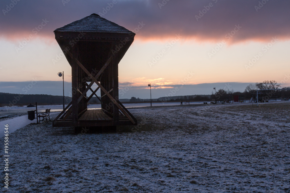  A wooden footbridge standing on riverside boulevards in the early morning