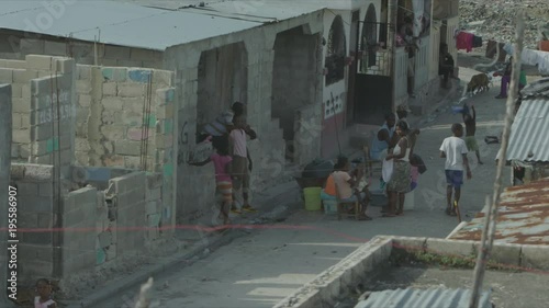 Kid Doing Hand Gesture to Camera, Street Life in Cité Soleil, Port-au-Prince photo