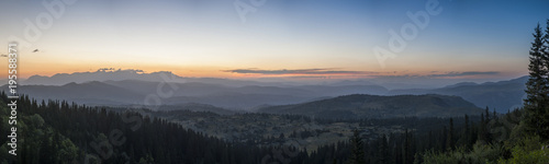 Sunset panorama landscape of mountains with forests