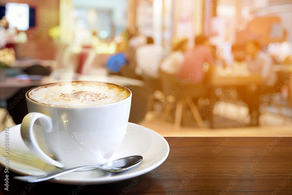 Cappuccino on the table with blur people at cafe background Cappuccino on the table with blur people at cafe background