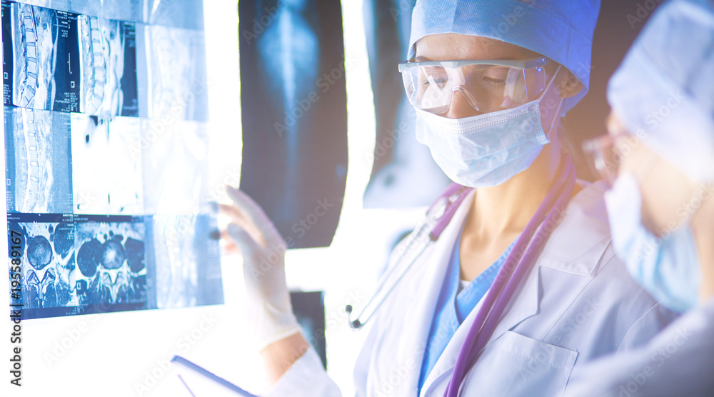 Two female women medical doctors looking at x-rays in a hospital. Two female women medical doctors looking at x-rays in a hospital.