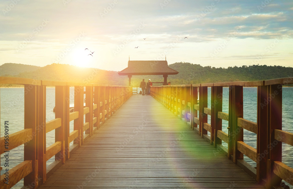 A wooden boat dock at the beautiful sunset A wooden boat dock at the beautiful sunset