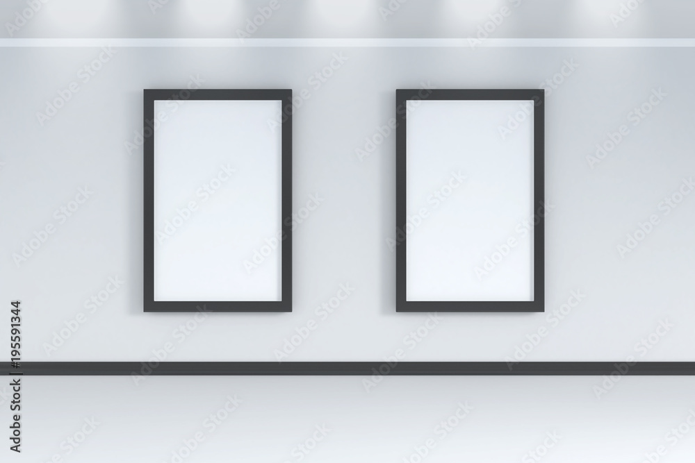 Two empty white frames on the white wall room with spot light above - 3d rendering Two empty white frames on the white wall room with spot light above - 3d rendering
