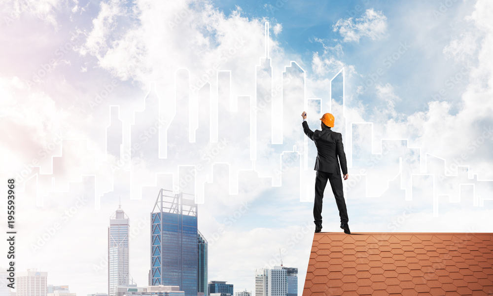 Man architect draw silhouette of modern city on blue sky. Mixed media Man architect draw silhouette of modern city on blue sky. Mixed media