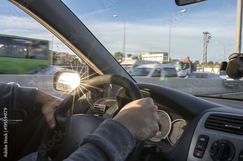 Driving with annoying sun reflections from rear view mirror photo