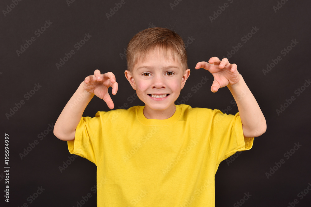 Emotional guy. Portrait of a boy in a T-shirt. Shooting in the studio. A young man on a black background. Emotional guy. Portrait of a boy in a T-shirt. Shooting in the studio. A young man on a black background.
