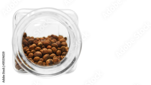 glass jar for spices with peas of pepper. Isolated on white background. copy space  template.