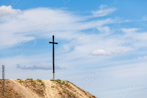 tall wooden cross on hill