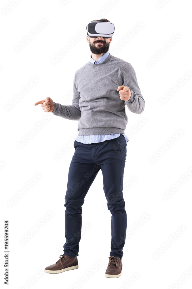 Happy excited adult man wearing vr glasses pointing finger resizing gesture. Full body isolated on white background. Happy excited adult man wearing vr glasses pointing finger resizing gesture. Full body isolated on white background.