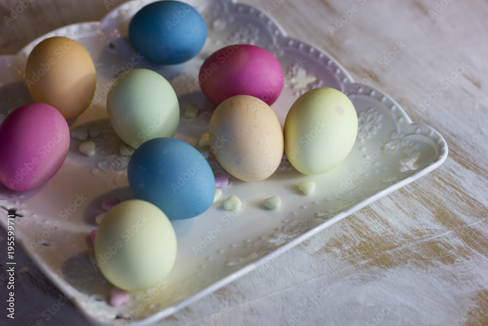 colorful easter eggs on a plate and a dark wooden background colorful easter eggs on a plate and a dark wooden background