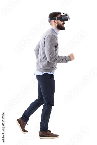Profile view of smart casual business man wearing vr glasses running and looking up. Full body isolated on white background.