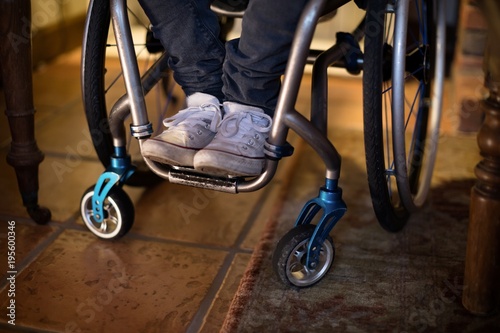 Disabled man in wheelchair at home photo