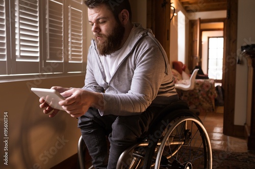 Disabled man using digital tablet photo