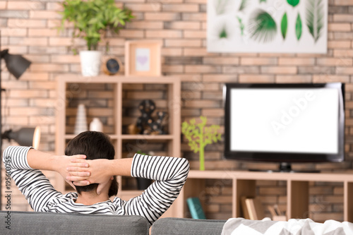 Relaxed man watching televi...