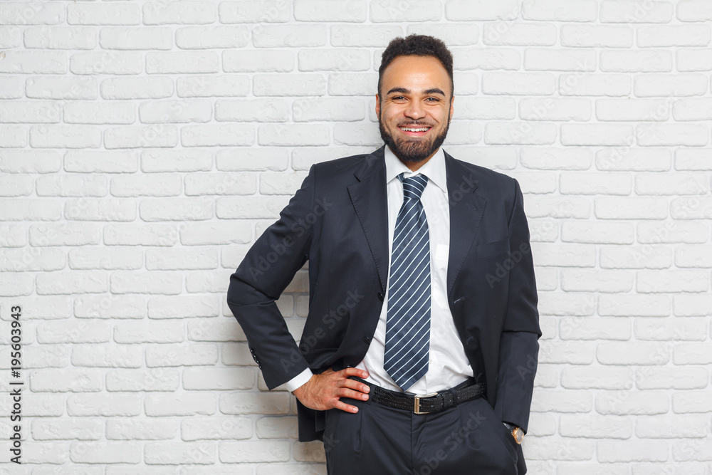 Young fashionable men in a suit against brick wall