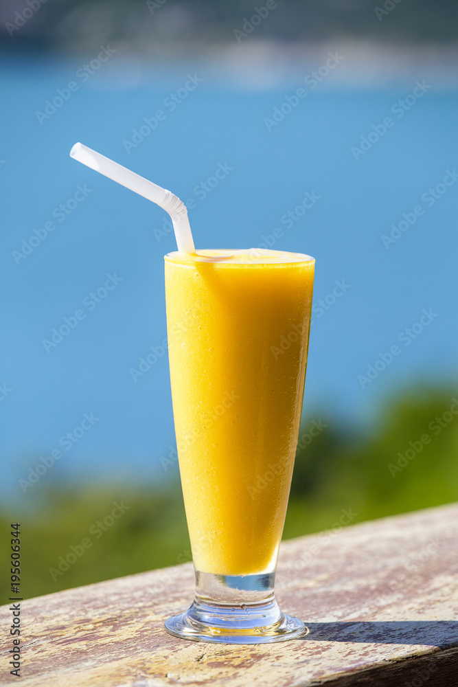 Fresh organic Mango shake in thai restaurant on the beach near sea , Thailand. Close up Fresh organic Mango shake in thai restaurant on the beach near sea , Thailand. Close up