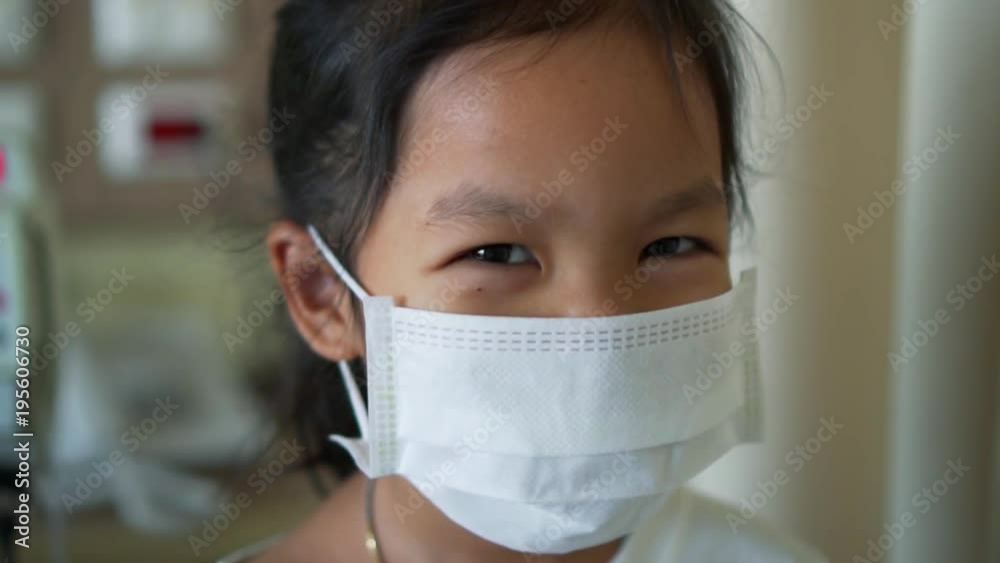 Sick asian little child girl wear protection mask while live in the hospital in slow motion shot Sick asian little child girl wear protection mask while live in the hospital in slow motion shot