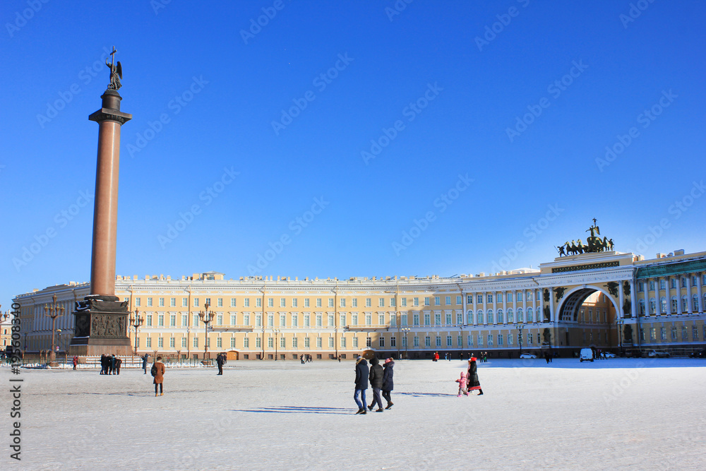 Obraz premium Palace Square Winter Panorama in St. Petersburg, Russia. Alexander Column and Arch of General Staff Building Scenic Cityscape View with Tourists Walking Around. Sunny Winter Day Travel Wallpaper. 