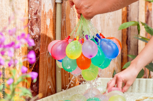 Filling colorful  water balloons with water