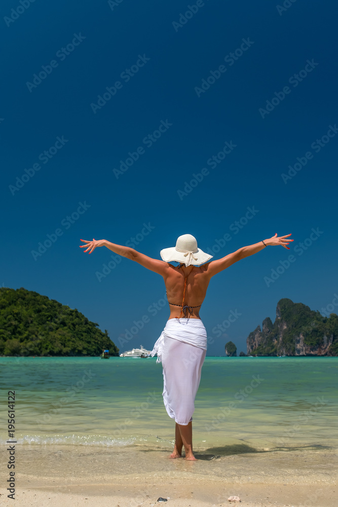 lady in black beachwear, floppy hat, sunglasses enjoying sun on tropical destination during summer vacation in Thailand lady in black beachwear, floppy hat, sunglasses enjoying sun on tropical destination during summer vacation in Thailand