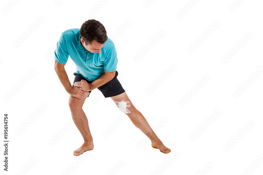 Young man with elastic bandage on knee, on a white background. Man on crutches, after the operation Young man with elastic bandage on knee, on a white background. Man on crutches, after the operation