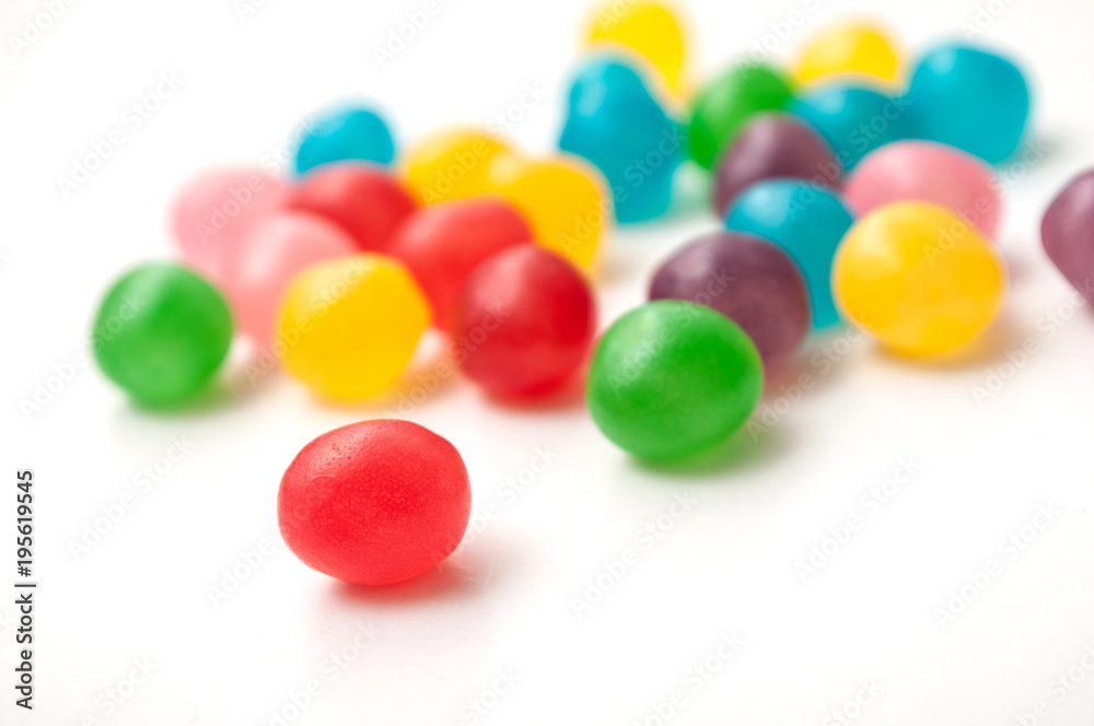 closeup of colorful round candies on white background closeup of colorful round candies on white background
