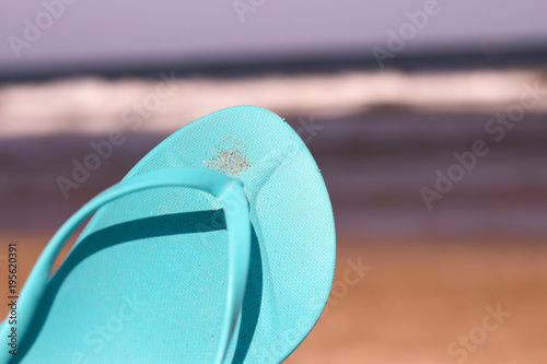 Flip flops on the sand of the beach