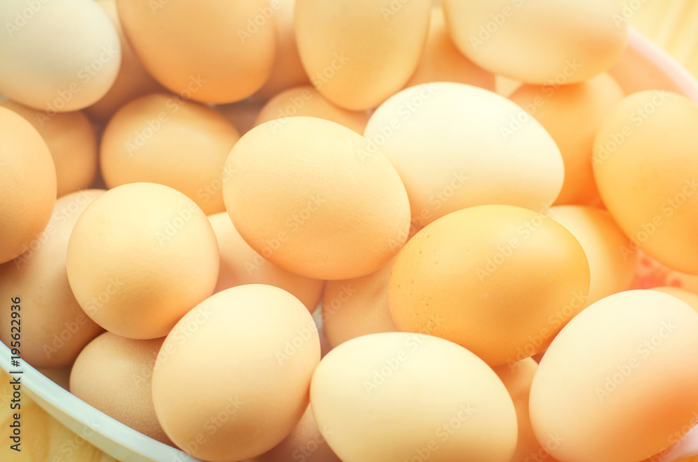 white and brown fresh chicken eggs in a plate. concept of easter. cooking ingredients white and brown fresh chicken eggs in a plate. concept of easter. cooking ingredients