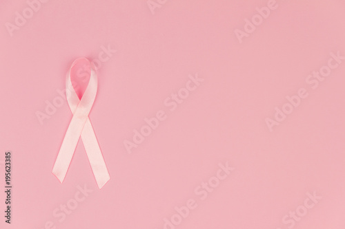 Pink tape as symbol of women illness mammary cancer isolated on pink background