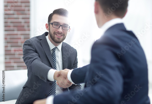 Two colleagues shaking hands after a business meeting