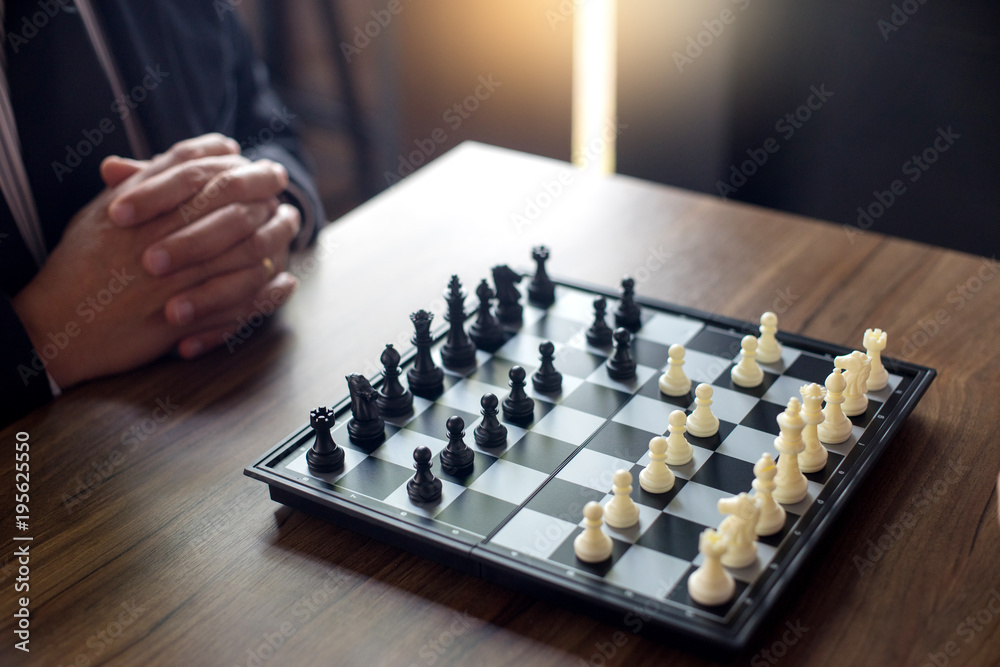 Businessman thinking how to play chess concept business strategy