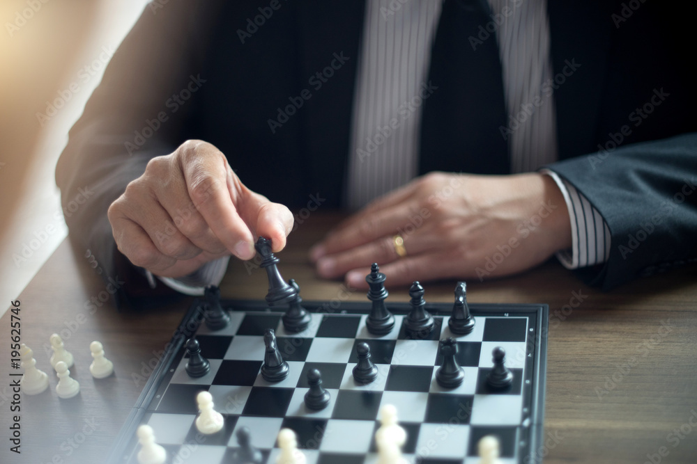 Businessman thinking how to play chess concept business strategy Businessman thinking how to play chess concept business strategy
