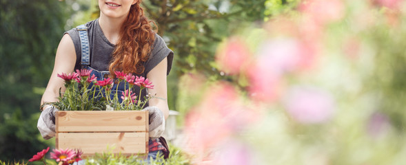 Woman carrying a flowerpot