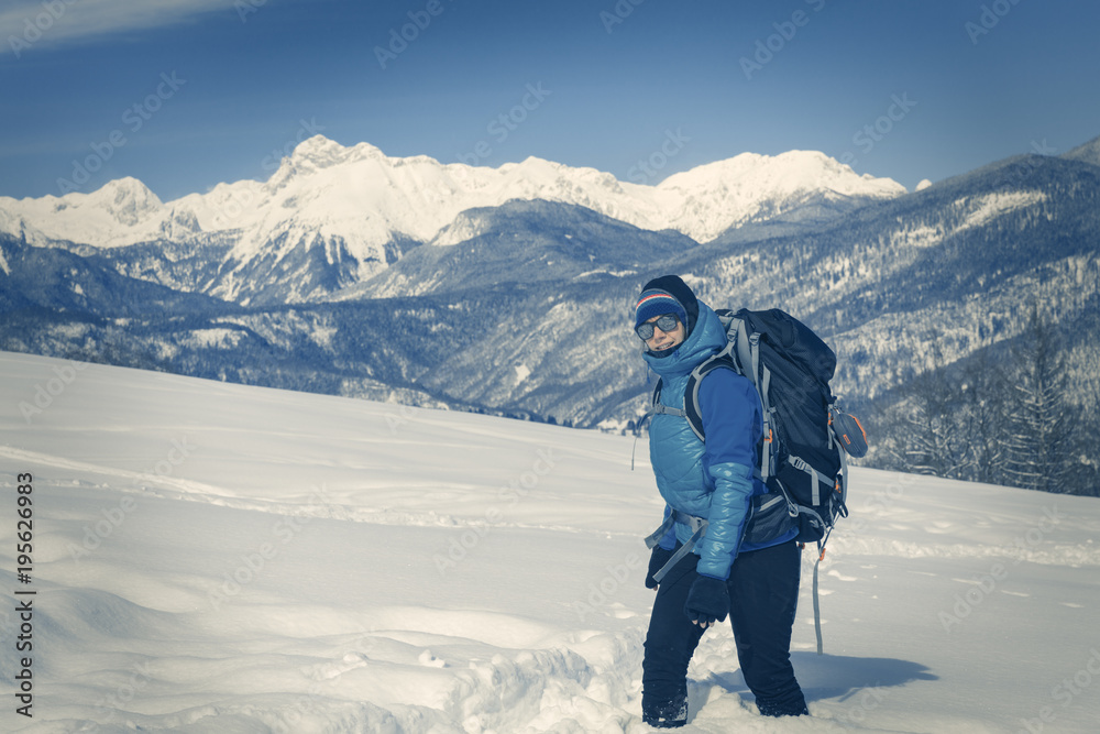 A Hiker trekking in winter landscape.