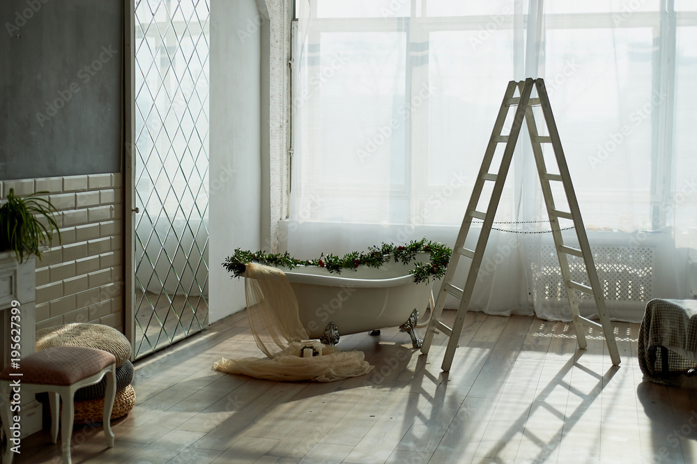 Bath on lion's paws, decorated with flowers. On the floor are candles. A romantic setting for a date Bath on lion's paws, decorated with flowers. On the floor are candles. A romantic setting for a date