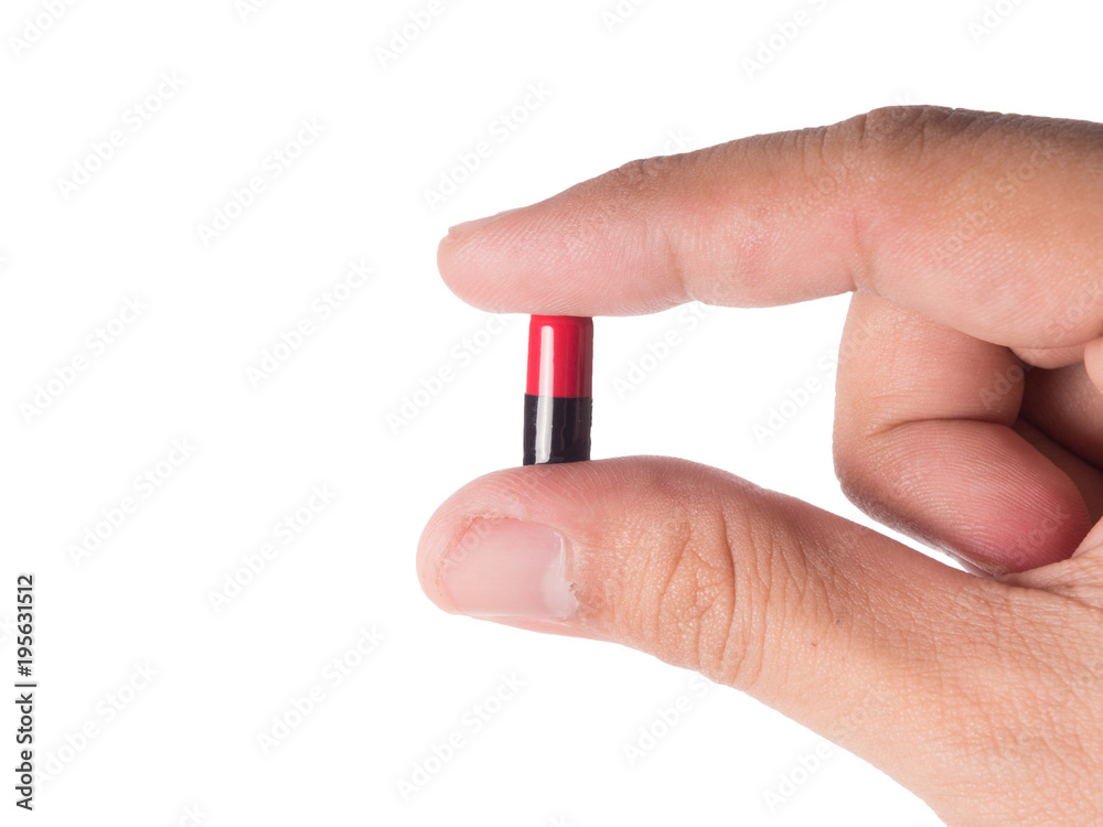 Hand holding a capsule or pill isolated on white. Hand holding a capsule or pill isolated on white.