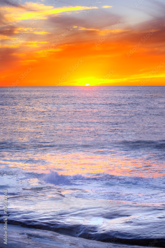 Pacific ocean sunset in California in Windansea beach in La Jolla, San Diego with orange sun reflection