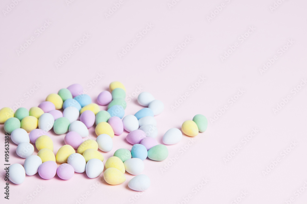 pastel colored easter eggs on a pink background