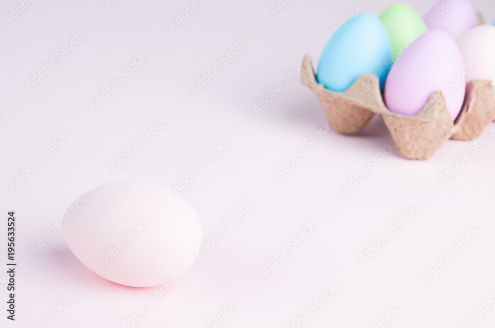 Fototapeta premium pastel colored easter eggs on a pale pink background
