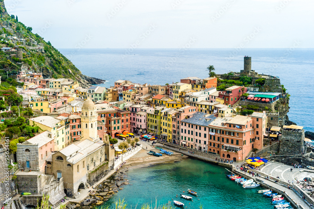 The small fishermen village of Vernazza, with its colorful houses and its church around its little port, is one of the five towns of the Cinque Terre in Liguria, Italy.