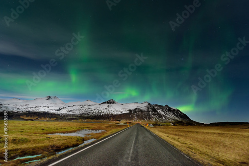 The Northern Light at the mountain in Iceland. Landscape with green bands of Aurora Borealis. Nightscape magical.