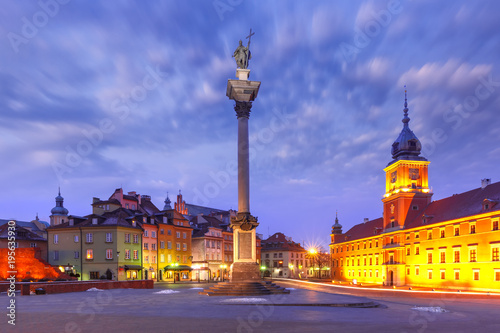 Castle Square with Royal Castle, colorful houses and Sigismund Column called Kolumna Zygmunta in Old town during morning blue hour, Warsaw, Poland.