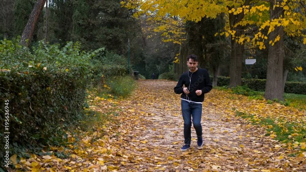 Funny happy young man in the park dancing listening music Funny happy young man in the park dancing listening music