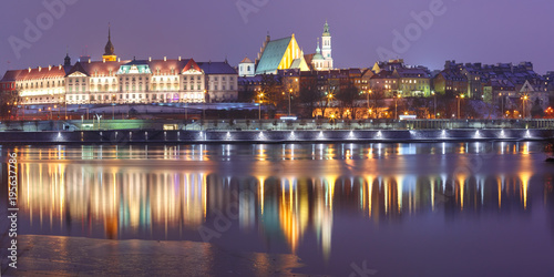 Panorama of the Old Town with reflection in the Vistula River during evening blue hour, Warsaw, Poland.